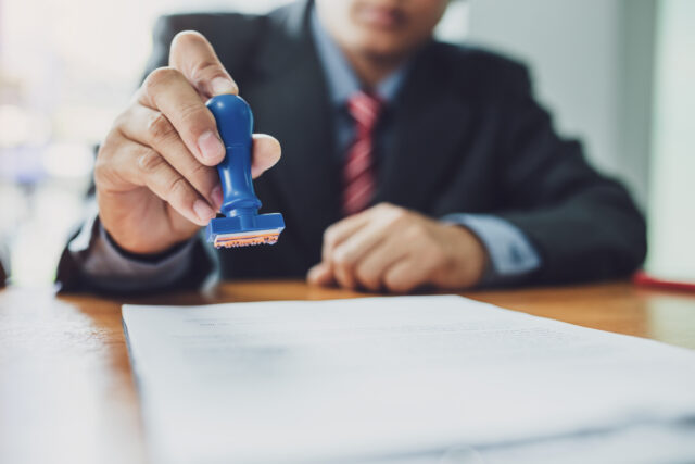 man stamping work permit